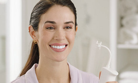 Girl showing off smile in the mirror